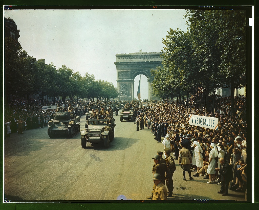 Crowds of French patriots line the Champs Elysees to view Allied tanks and half tracks pass through the Arc du Triomphe, after Paris was liberated on August 25, 1944